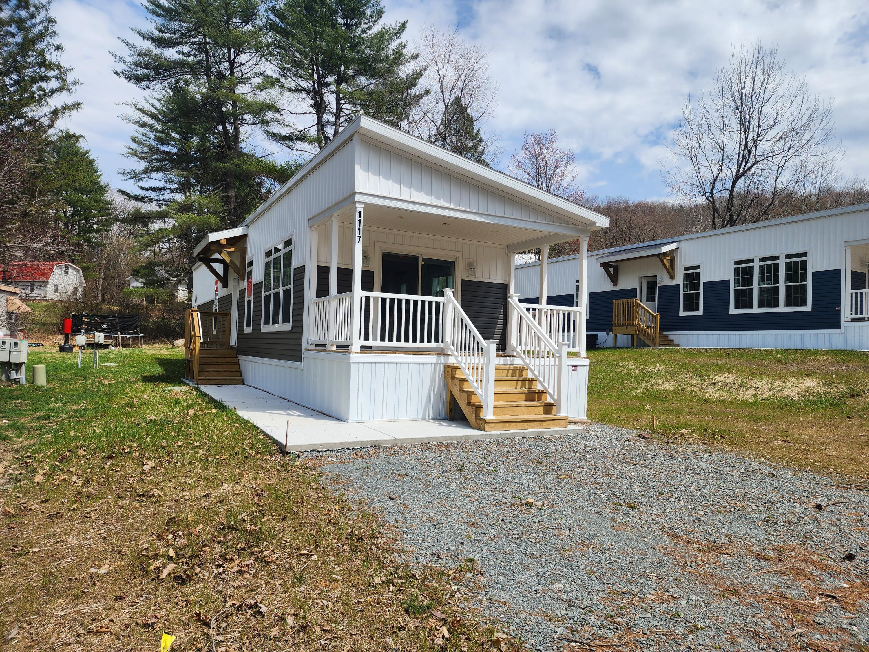 a front view of house with yard and swimming pool