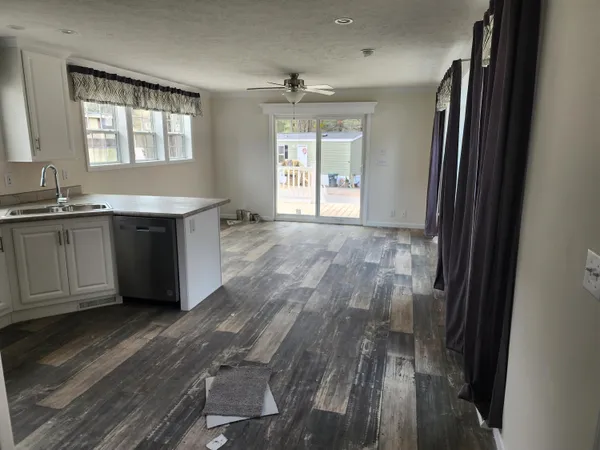 a room with wooden floor and window