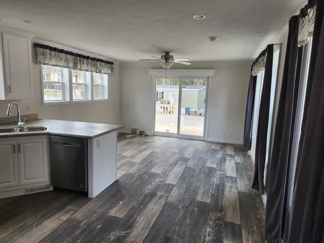 a kitchen with granite countertop a refrigerator and a sink
