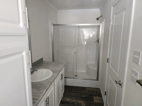 a bathroom with a granite countertop sink mirror vanity and toilet