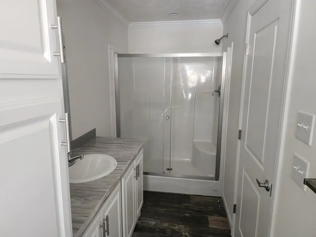 a bathroom with a granite countertop sink mirror vanity and toilet