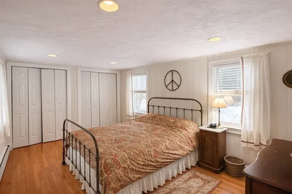 a bedroom with a bed and wooden floor