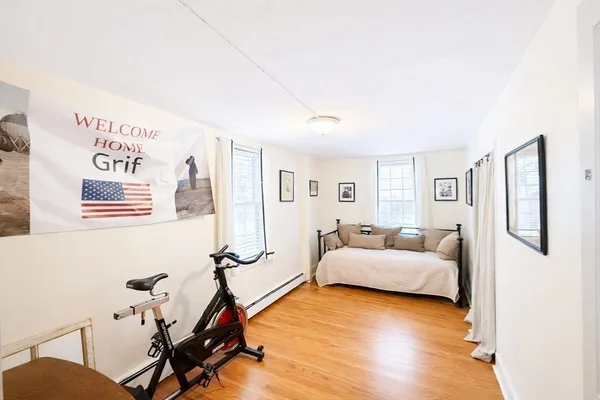 a bedroom with furniture and a wooden floor