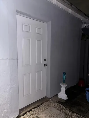 a bedroom with wooden floor and closet