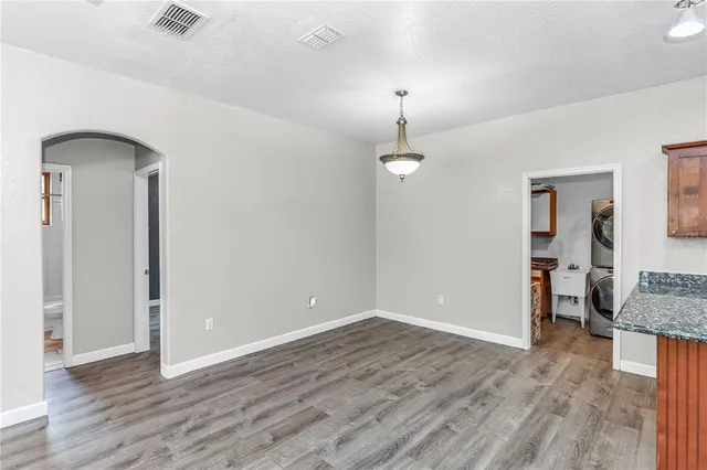 a kitchen with stainless steel appliances granite countertop a refrigerator a sink and wooden cabinets