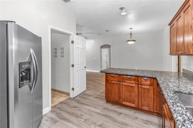a view of a hallway with wooden floor and front door