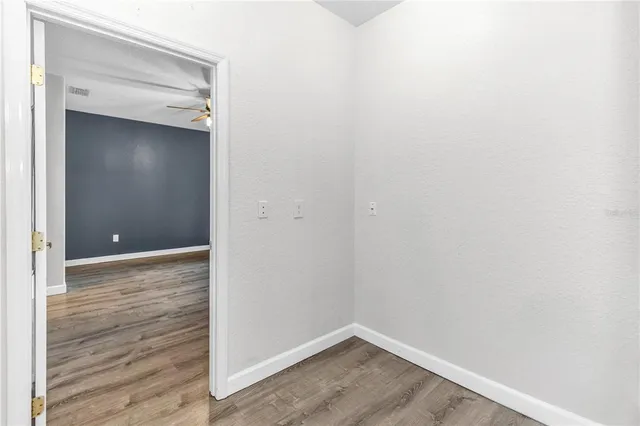a view of an empty room with wooden floor