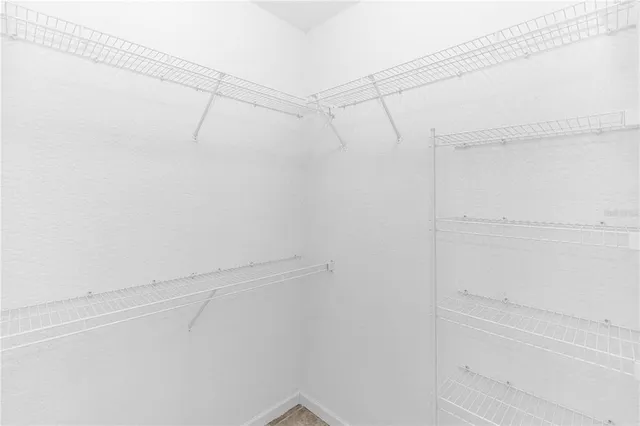 a bathroom with a granite countertop tub a sink and a mirror