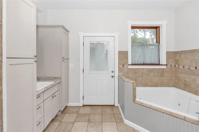 a kitchen with white cabinets and refrigerator
