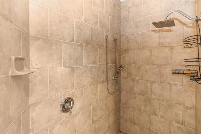 a bathroom with a bathtub and shower