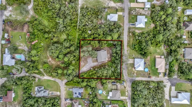 an aerial view of a houses with a yard