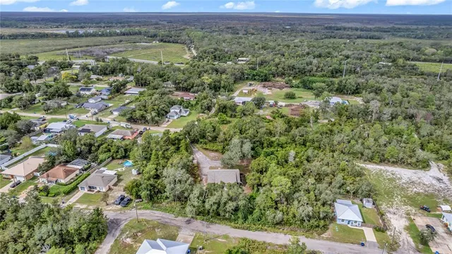 a view of a wooden house with a tree