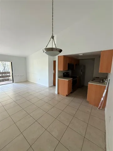 a kitchen with stainless steel appliances a stove a microwave and a refrigerator