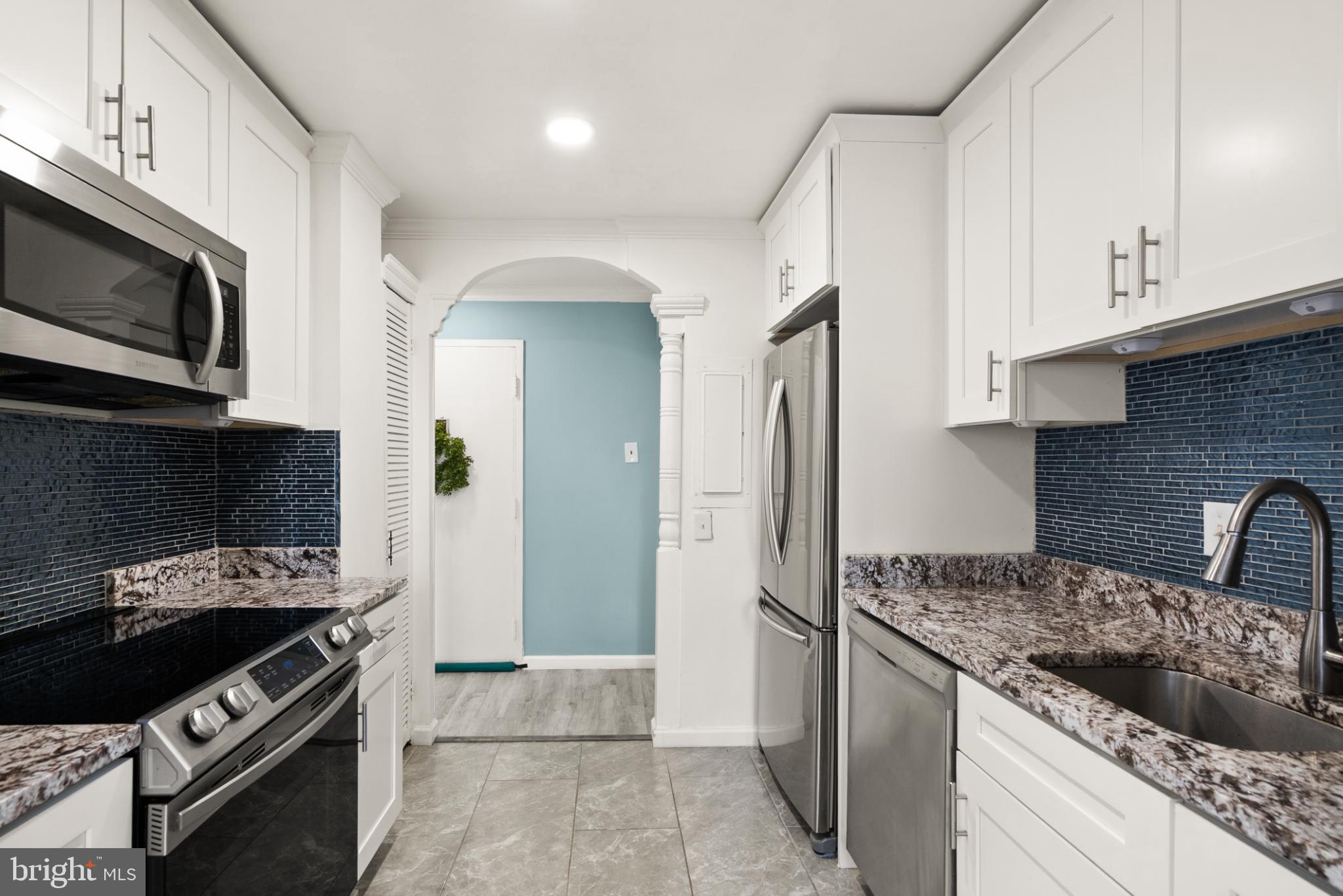 3245 Rio Drive, Unit 608 Falls Church, VA 22041 - Photo 21 of 40 a kitchen with stainless steel appliances granite countertop a stove and a refrigerator