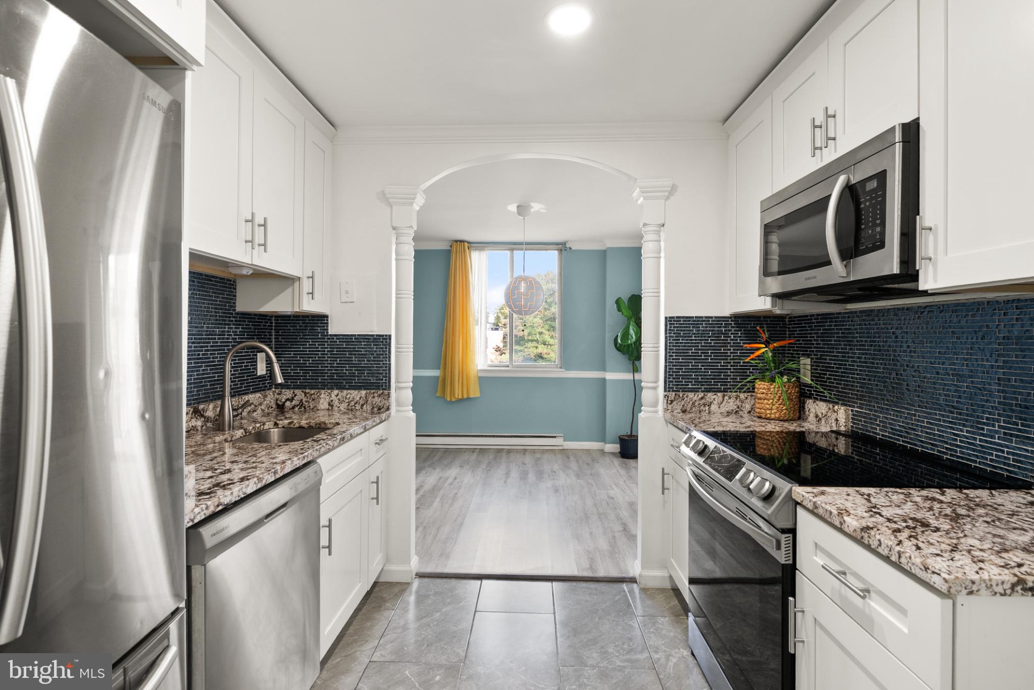 3245 Rio Drive, Unit 608 Falls Church, VA 22041 - Photo 22 of 40 a kitchen with stainless steel appliances granite countertop a stove a sink and a microwave