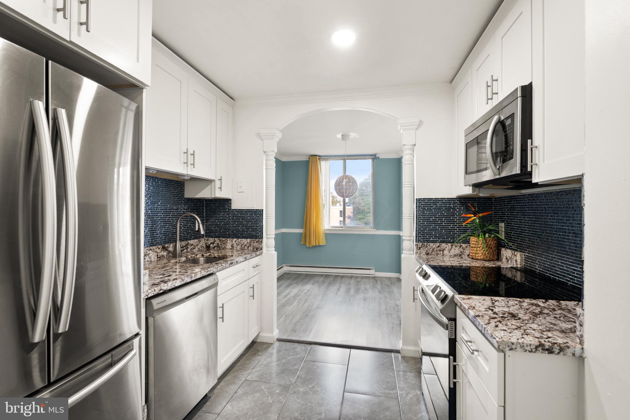 3245 Rio Drive, Unit 608 Falls Church, VA 22041 - Photo 23 of 40 a kitchen with stainless steel appliances granite countertop a refrigerator stove a sink dishwasher and microwave oven
