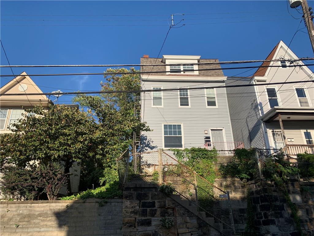 725 Clarissa Street Pittsburgh, PA 15219 - Photo 1 of 14 a front view of a house with a yard