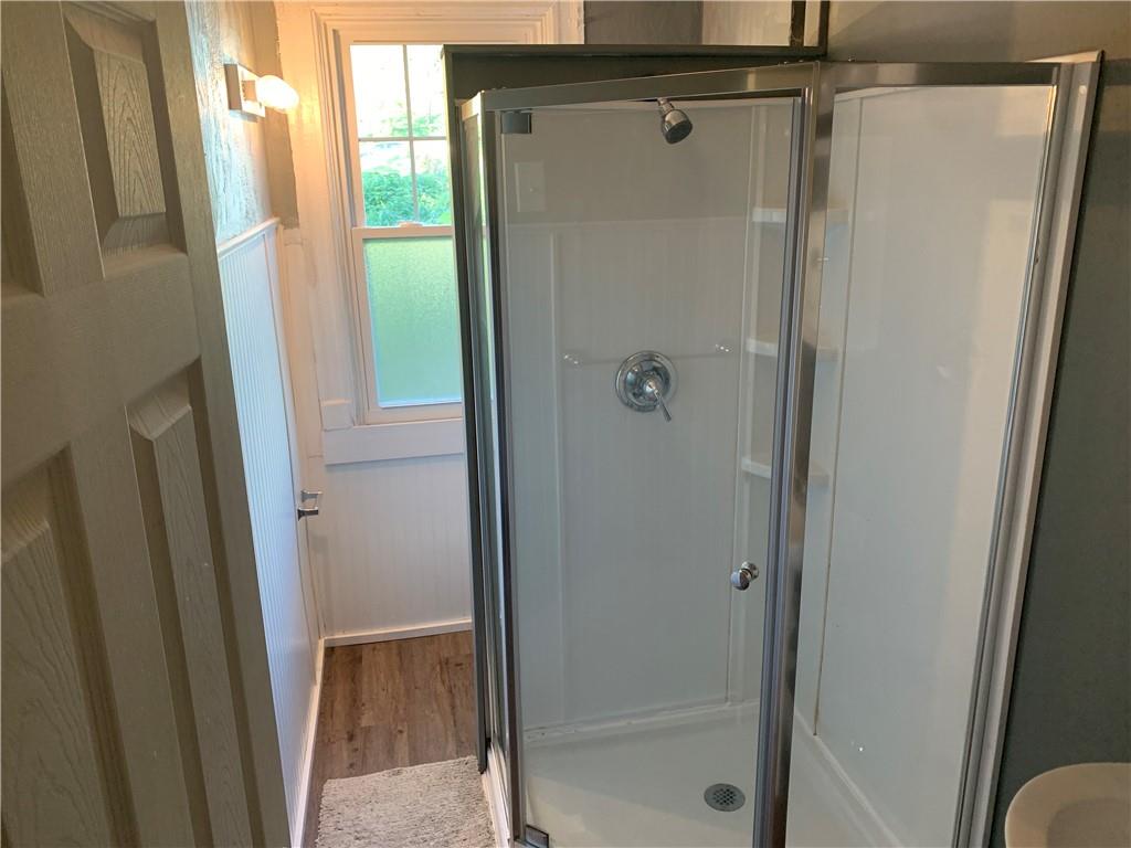 725 Clarissa Street Pittsburgh, PA 15219 - Photo 13 of 14 a bathroom with a glass door shower