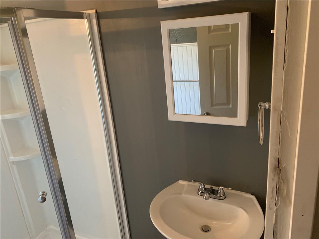 725 Clarissa Street Pittsburgh, PA 15219 - Photo 14 of 14 a bathroom with a sink and a mirror