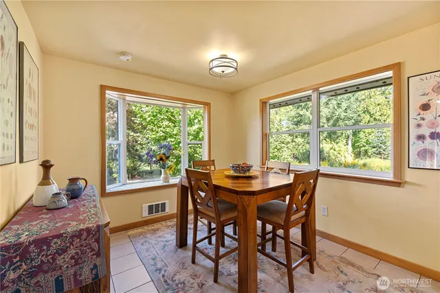 a view of a dining room with furniture and a window