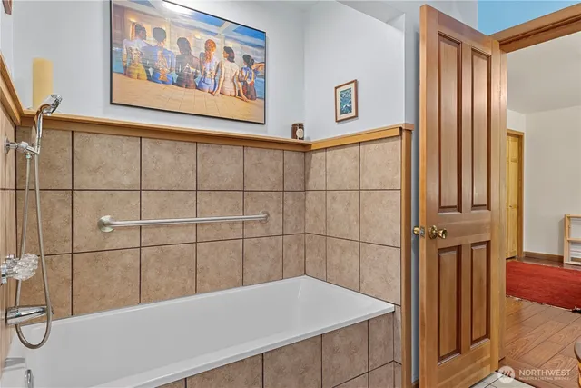 a bathroom with a bathtub and shower