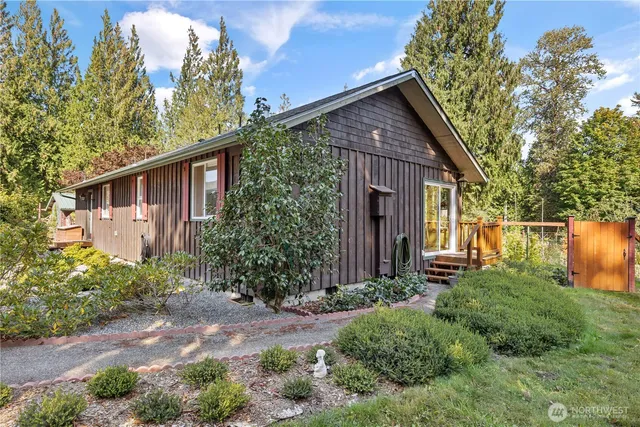 a front view of house with yard and trees around