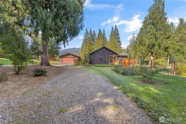 a view of a house with a yard and tree s