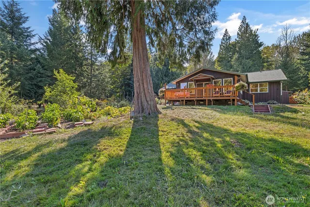 a front view of a house with yard and green space