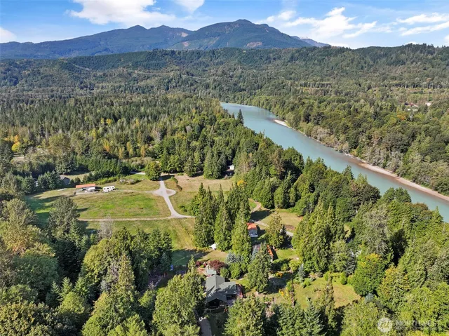 a view of a lush green hillside and a houses