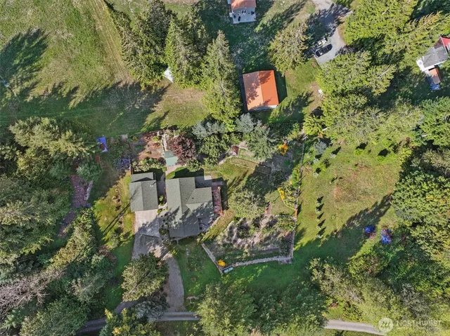 an aerial view of a house with a yard