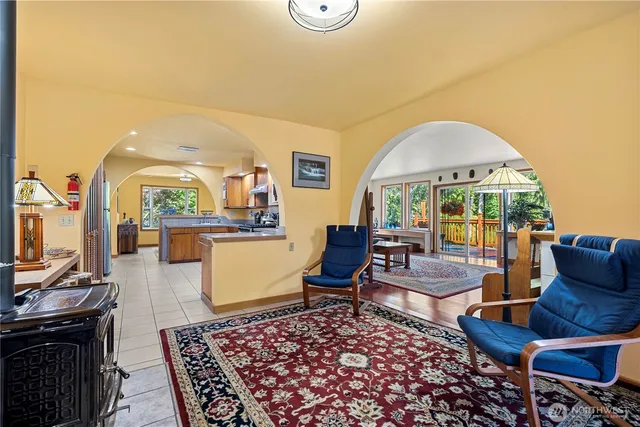 a living room with fireplace furniture and a large window