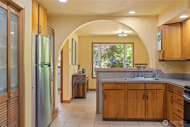 a kitchen with a refrigerator and a sink