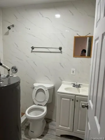 a bathroom with a sink toilet and a mirror