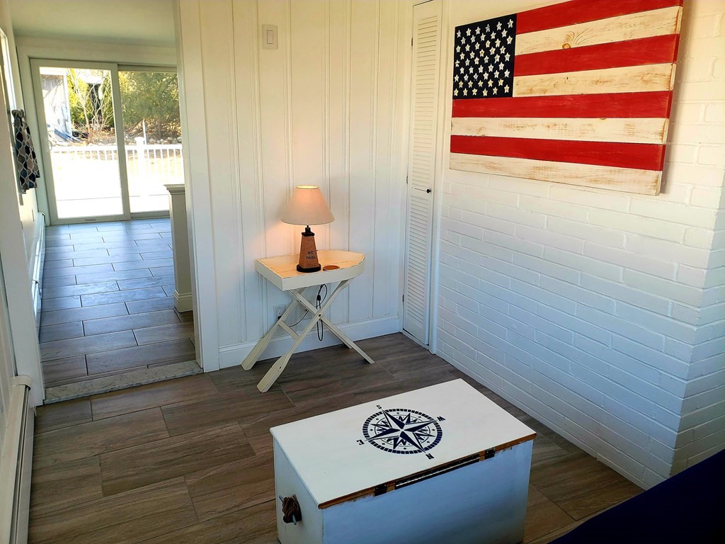 18 Harvard Road Dennis, MA 02639 - Photo 13 of 32 a view of a hallway with wooden floor and a bathroom