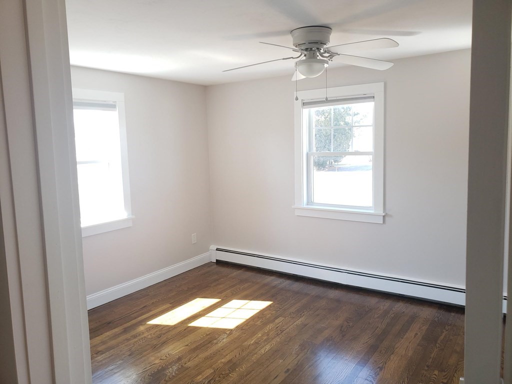18 Harvard Road Dennis, MA 02639 - Photo 15 of 32 an empty room with a window and wooden floor