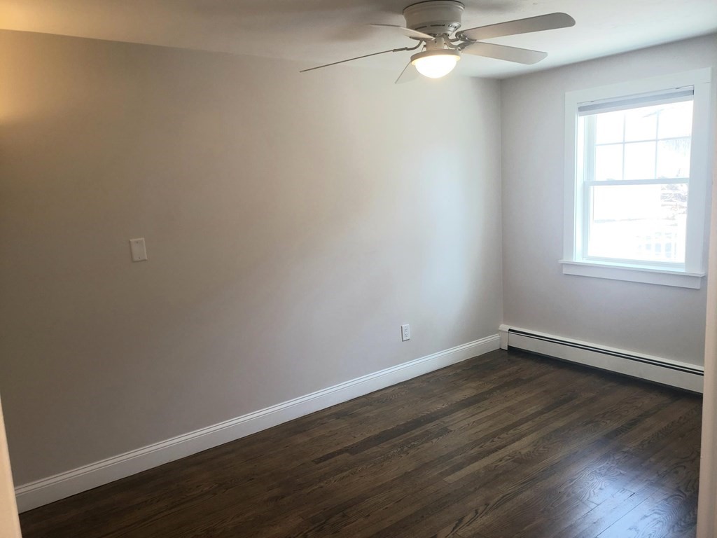 18 Harvard Road Dennis, MA 02639 - Photo 16 of 32 a view of an empty room with wooden floor and a window