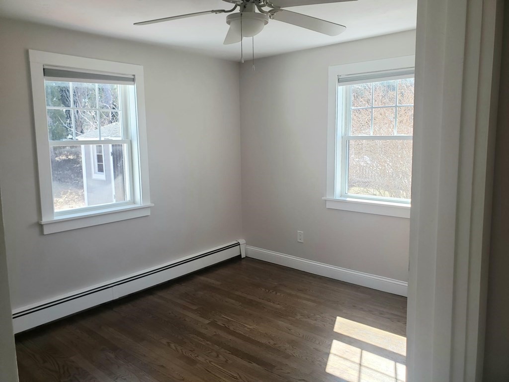 18 Harvard Road Dennis, MA 02639 - Photo 17 of 32 an empty room with a window and a chandelier fan