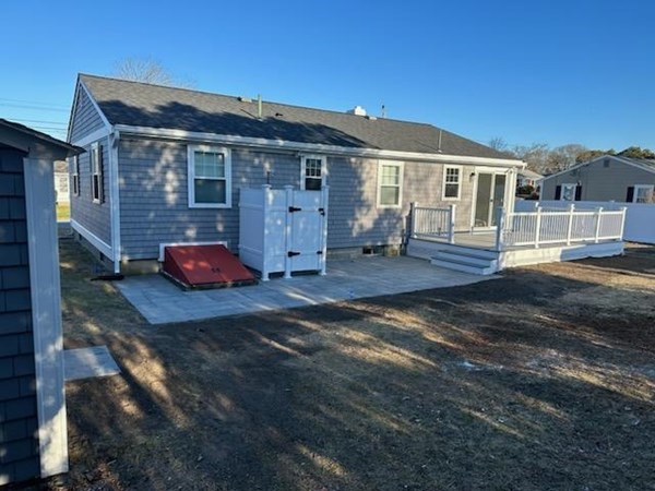 18 Harvard Road Dennis, MA 02639 - Photo 2 of 32 a backyard of a house with seating space