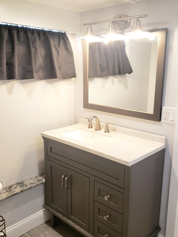 18 Harvard Road Dennis, MA 02639 - Photo 21 of 32 a bathroom with a sink and a mirror