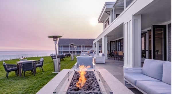 18 Harvard Road Dennis, MA 02639 - Photo 31 of 32 a view of a patio with couches table and chairs with wooden floor and fence