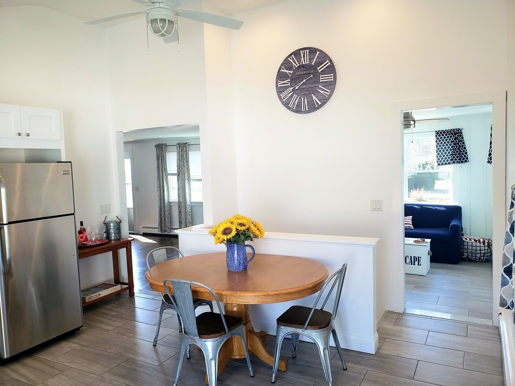 18 Harvard Road Dennis, MA 02639 - Photo 8 of 32 a view of a dining room with furniture and wooden floor