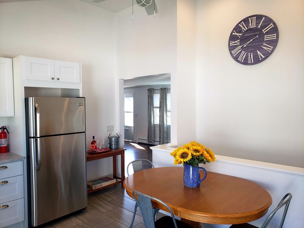 18 Harvard Road Dennis, MA 02639 - Photo 9 of 32 a kitchen with stainless steel appliances a dining table and chairs