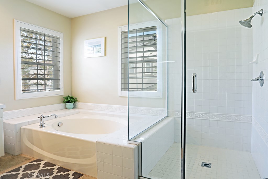 9 Orange Blossom Circle Ladera Ranch, CA 92694 - Photo 17 of 24 a bathroom with a bathtub and a shower