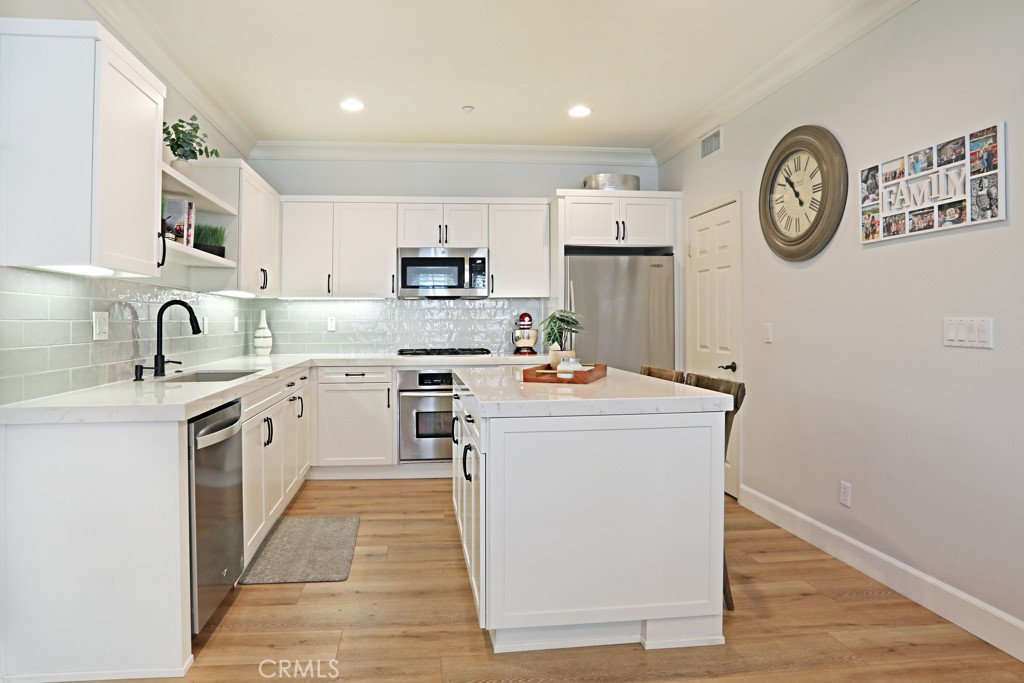 9 Orange Blossom Circle Ladera Ranch, CA 92694 - Photo 9 of 24 a kitchen with a sink cabinets and a refrigerator