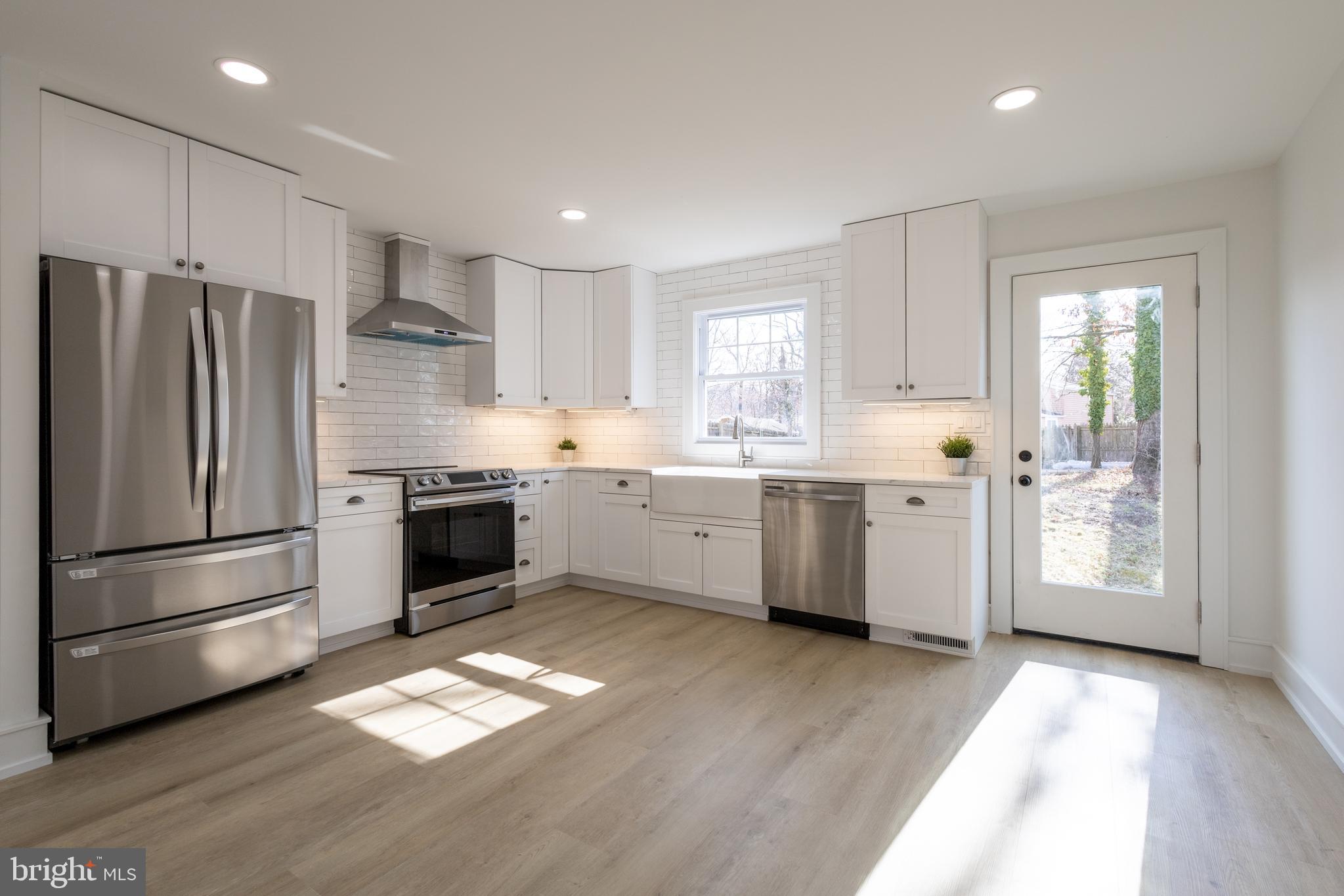 a kitchen with a white cabinets and white stainless steel appliances