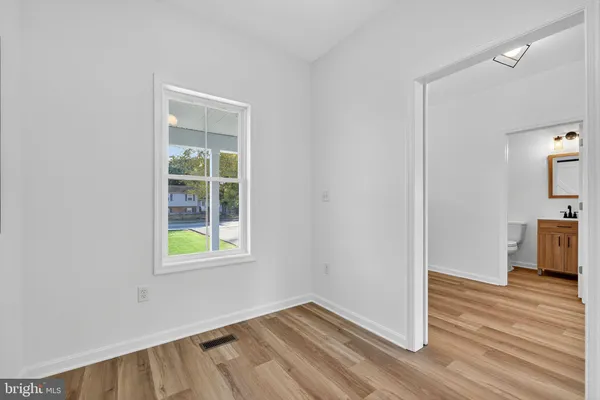 an empty room with windows and closet