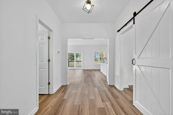 a view of a hallway view with wooden floor and staircase
