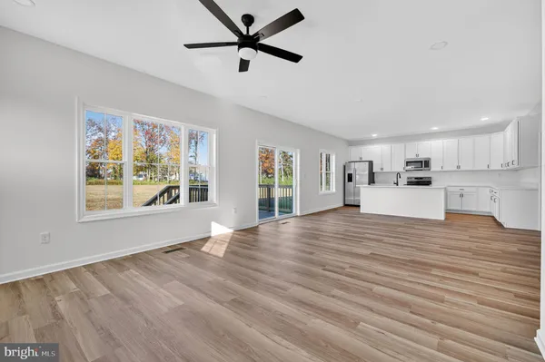 a view of a kitchen with a dishwasher cabinets and wooden floor