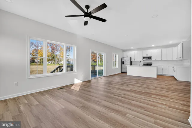 a view of a kitchen with a dishwasher cabinets and wooden floor