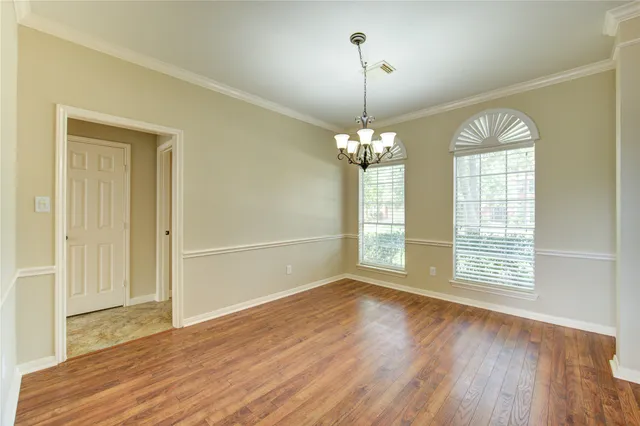 a view of a livingroom with wooden floor and a ceiling fan